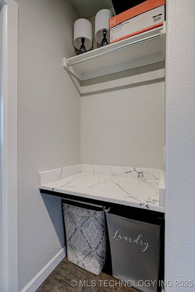 details featuring wood finished floors and baseboards