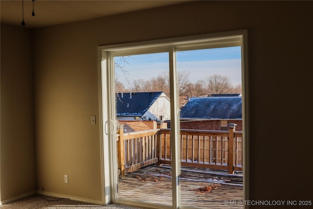 doorway to outside with carpet flooring