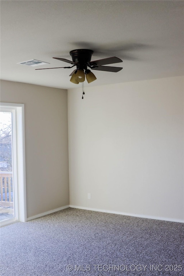 carpeted empty room featuring ceiling fan