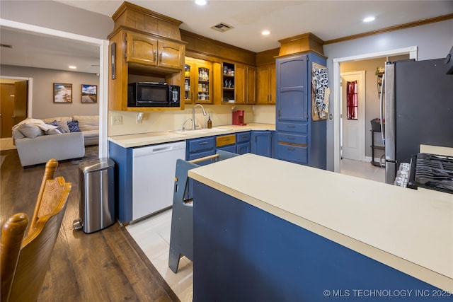 kitchen featuring white dishwasher, light hardwood / wood-style flooring, crown molding, stainless steel fridge, and sink