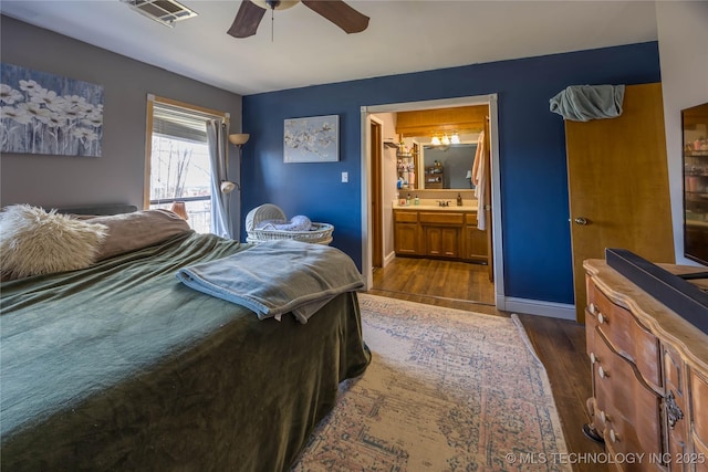 bedroom featuring sink, dark wood-type flooring, connected bathroom, and ceiling fan