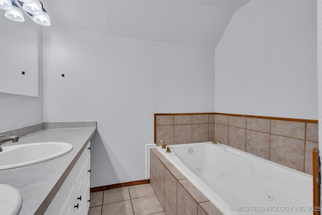 bathroom with tile patterned floors, vaulted ceiling, vanity, and tiled tub