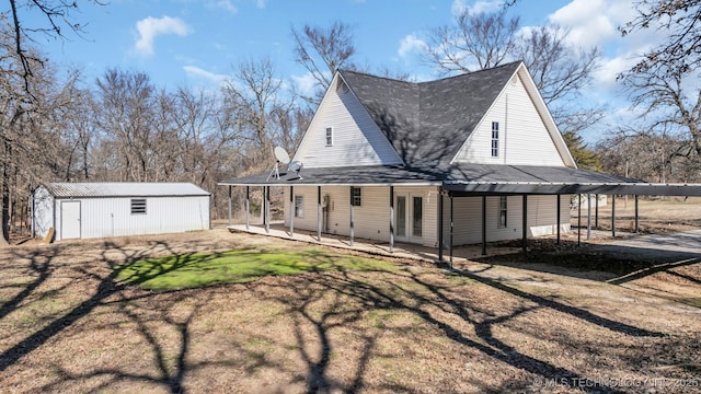 back of property with a shed and a carport