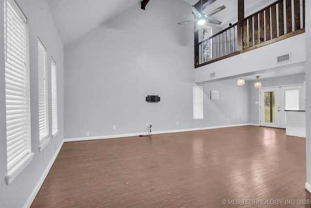 unfurnished living room featuring high vaulted ceiling, ceiling fan, french doors, and dark hardwood / wood-style floors