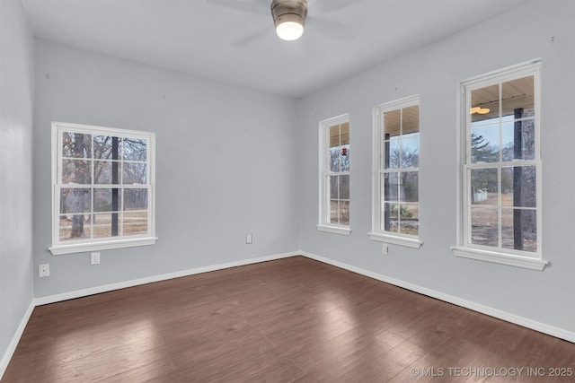 unfurnished room featuring ceiling fan and dark hardwood / wood-style floors