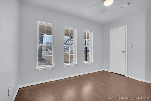 spare room with dark hardwood / wood-style floors and ceiling fan