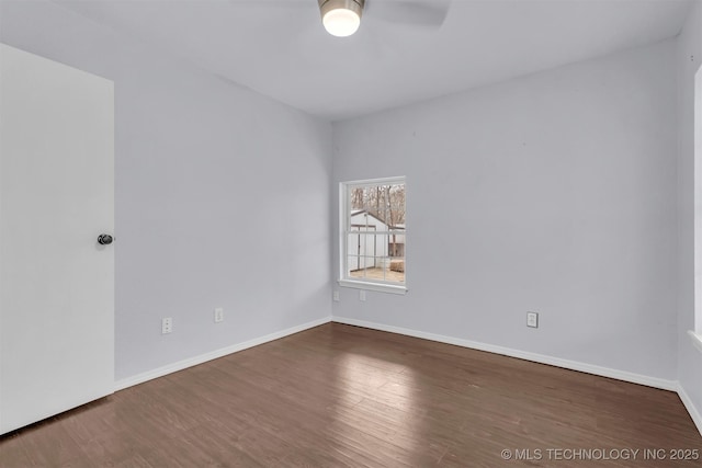 spare room featuring ceiling fan and dark hardwood / wood-style floors