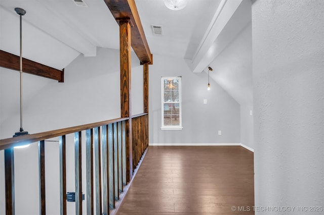 hallway with dark hardwood / wood-style flooring and lofted ceiling with beams