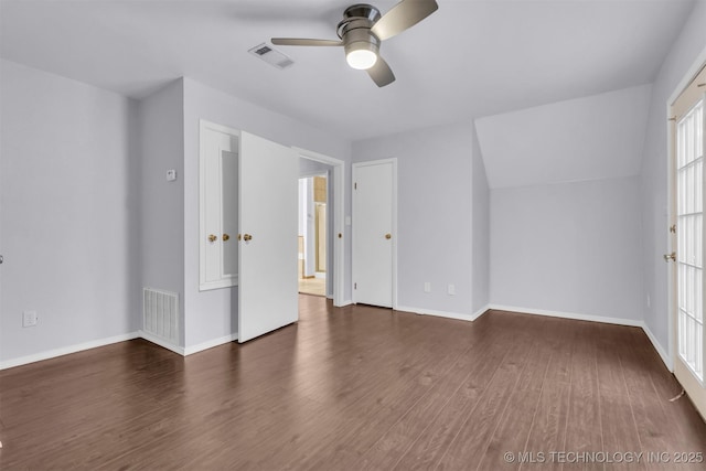 interior space with lofted ceiling, dark hardwood / wood-style floors, and ceiling fan