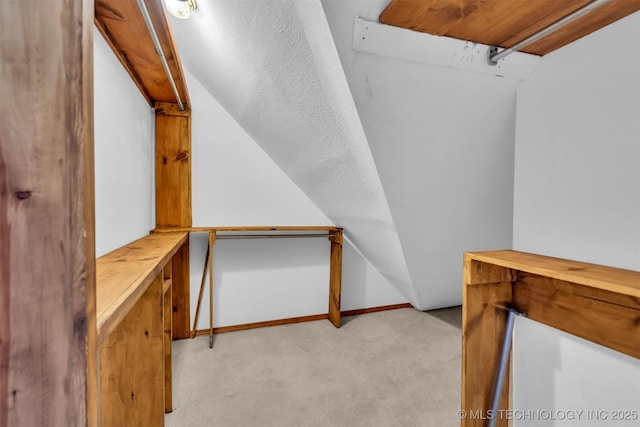 walk in closet featuring light colored carpet