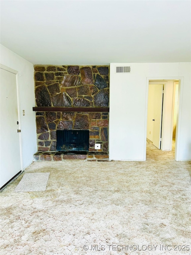 unfurnished living room featuring a fireplace and carpet flooring