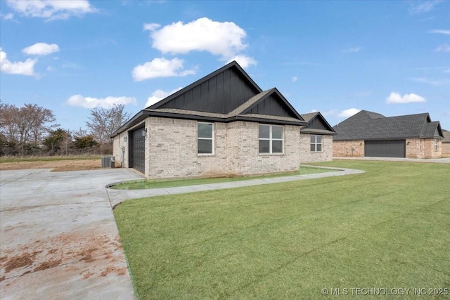 view of front facade featuring a front lawn, a garage, and central air condition unit