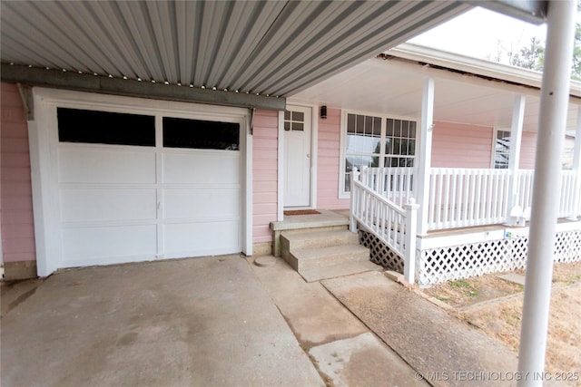 entrance to property featuring a garage and driveway