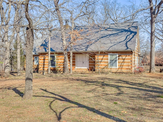 log cabin with a front yard