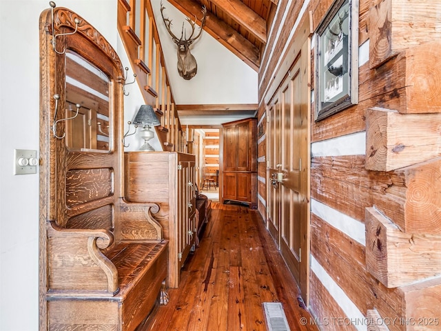 hallway featuring vaulted ceiling with beams and dark wood-type flooring