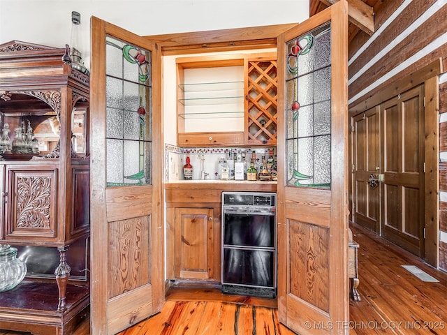 bar featuring hardwood / wood-style flooring