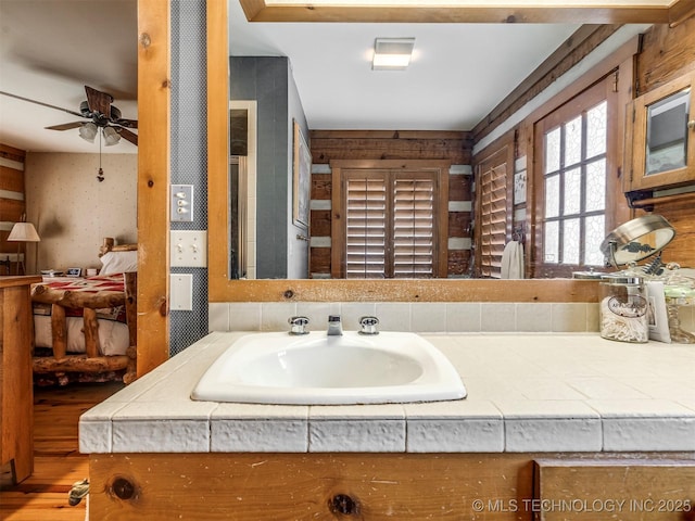 bathroom featuring ceiling fan and sink