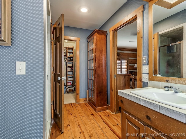 bathroom featuring vanity, hardwood / wood-style floors, and an enclosed shower