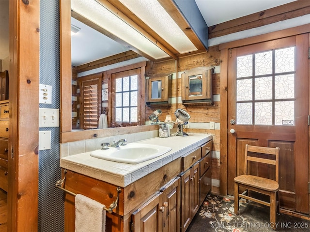 bathroom with vanity and wooden walls