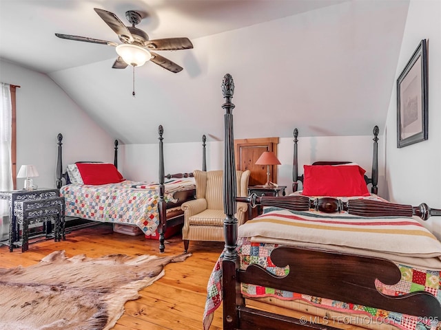 bedroom featuring lofted ceiling, ceiling fan, and wood-type flooring