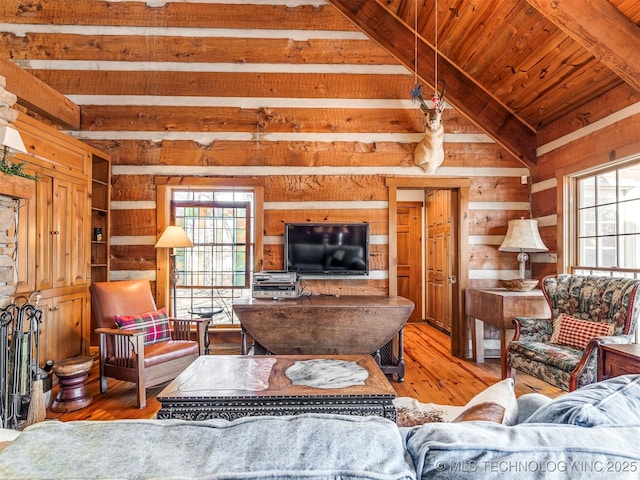 living room featuring wooden ceiling, wooden walls, vaulted ceiling with beams, and light hardwood / wood-style flooring