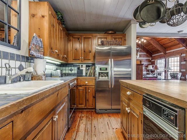 kitchen featuring tasteful backsplash, light hardwood / wood-style flooring, wooden ceiling, and stainless steel fridge with ice dispenser