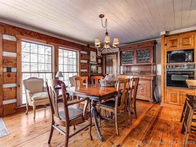 dining room featuring wooden ceiling, an inviting chandelier, and light hardwood / wood-style floors