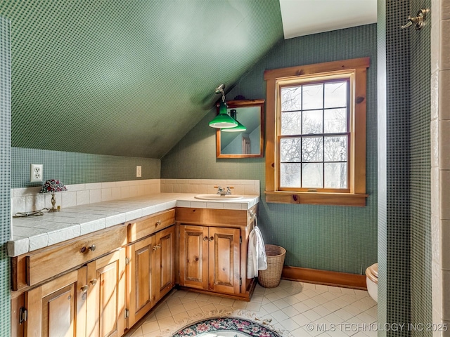 bathroom with vanity, tile patterned flooring, toilet, and lofted ceiling