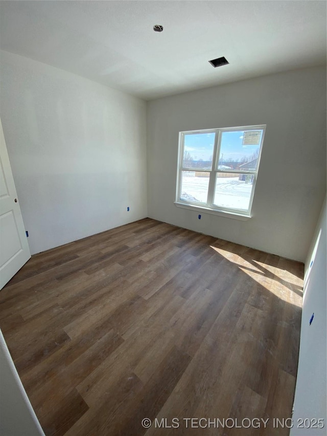 empty room featuring dark hardwood / wood-style flooring