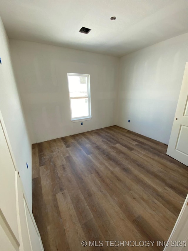 unfurnished room featuring dark hardwood / wood-style floors