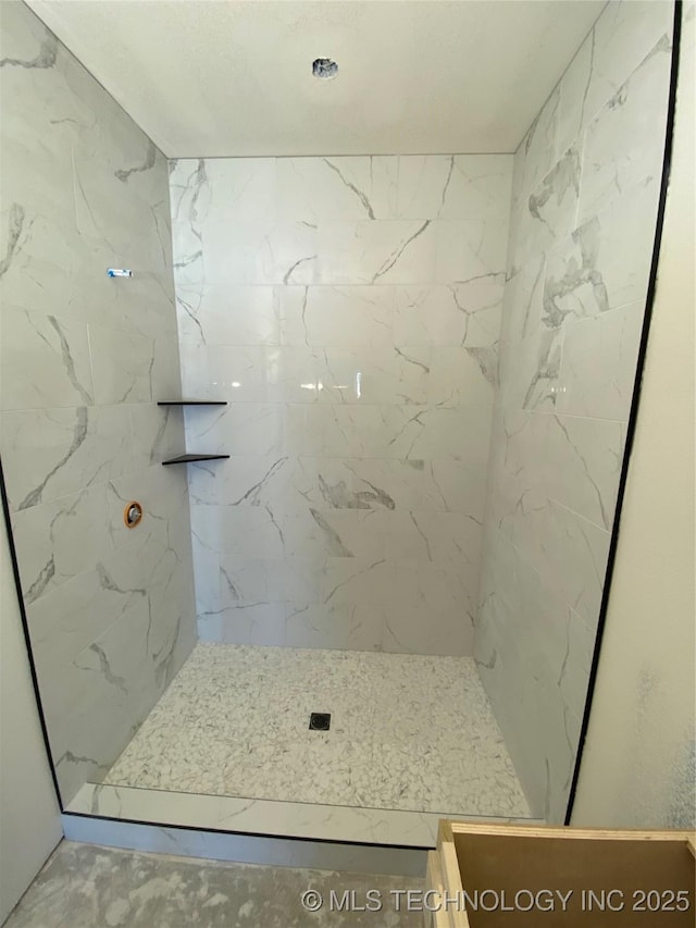 bathroom with tiled shower