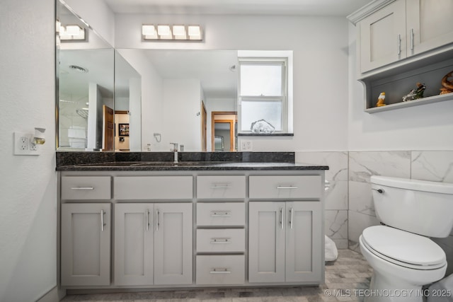42900 W 11th St, Terlton, OK 74081 - bathroom with tile walls, toilet, vanity, and a wainscoted wall
