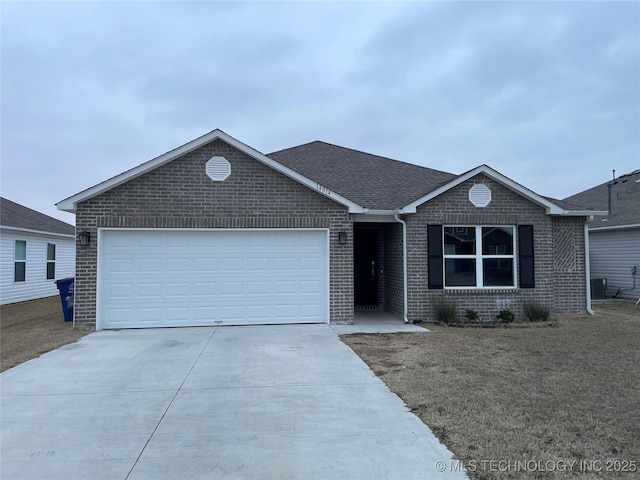 ranch-style home featuring driveway, an attached garage, roof with shingles, and brick siding