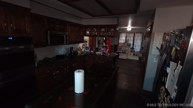 kitchen featuring backsplash, cooktop, dark brown cabinetry, and double oven