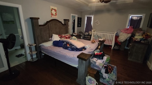 bedroom with dark wood-type flooring