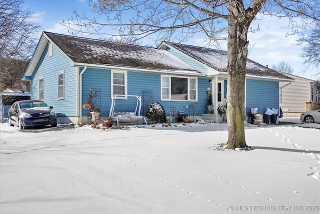 single story home featuring roof with shingles