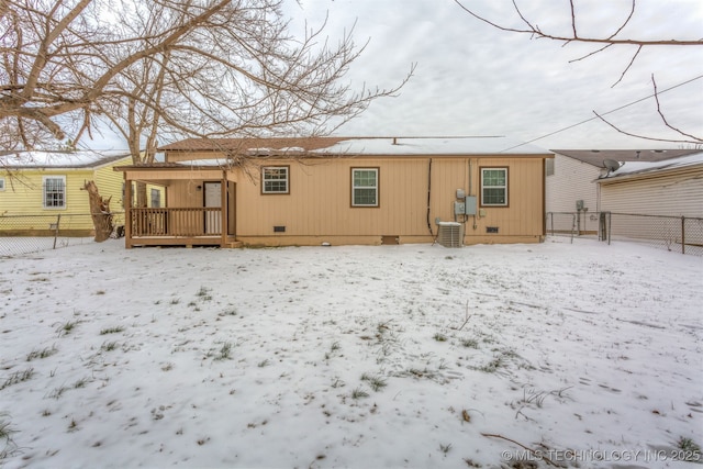 snow covered rear of property featuring crawl space, fence, and central air condition unit