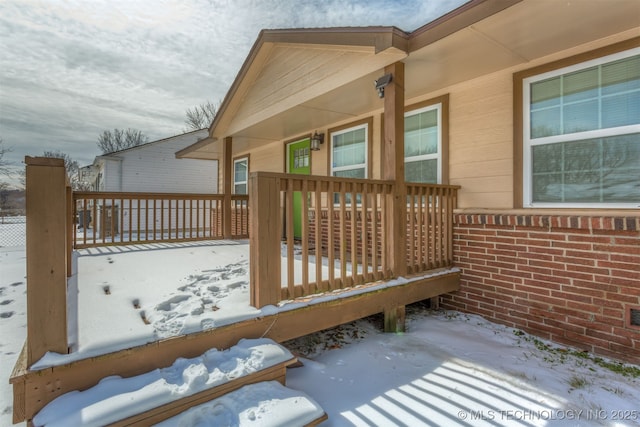 snow covered deck with covered porch