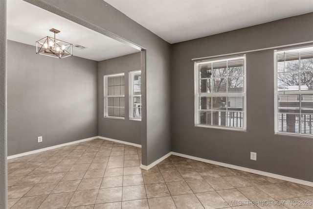 spare room with light tile patterned floors, visible vents, baseboards, and an inviting chandelier