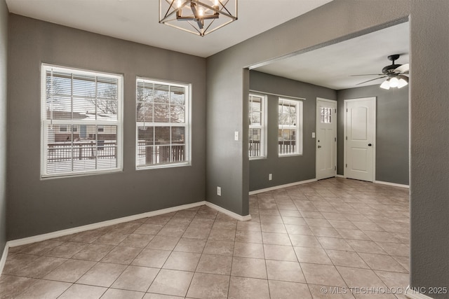 entrance foyer with baseboards, light tile patterned flooring, and a healthy amount of sunlight