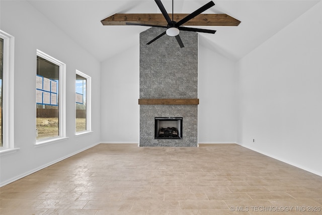 unfurnished living room featuring a large fireplace, baseboards, a ceiling fan, and beamed ceiling