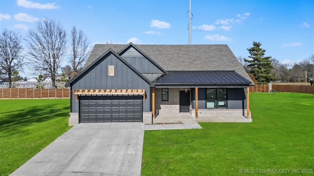 modern farmhouse with a porch, brick siding, driveway, and a front lawn