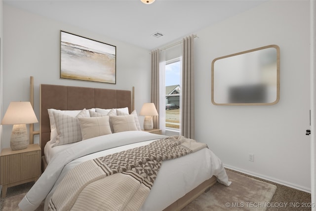 carpeted bedroom with visible vents and baseboards