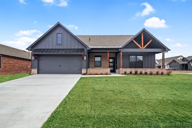 modern farmhouse with brick siding, board and batten siding, a front yard, a standing seam roof, and driveway