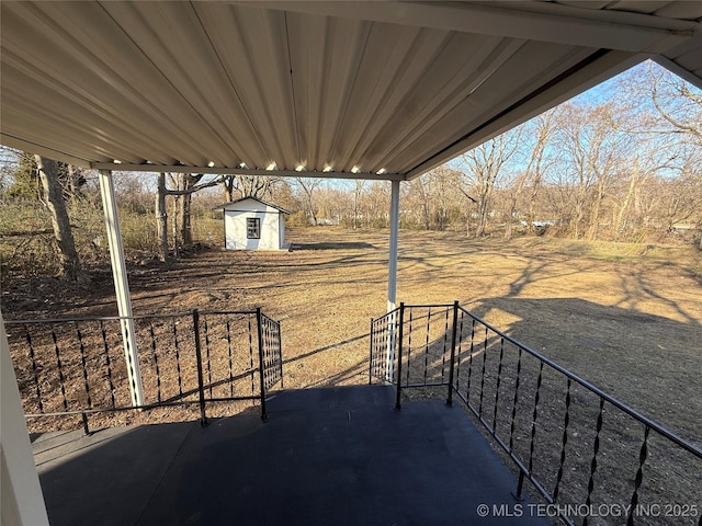 view of patio / terrace featuring an outdoor structure and a storage unit