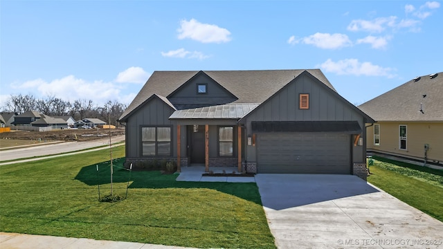 view of front of house featuring an attached garage, a shingled roof, concrete driveway, a front lawn, and board and batten siding