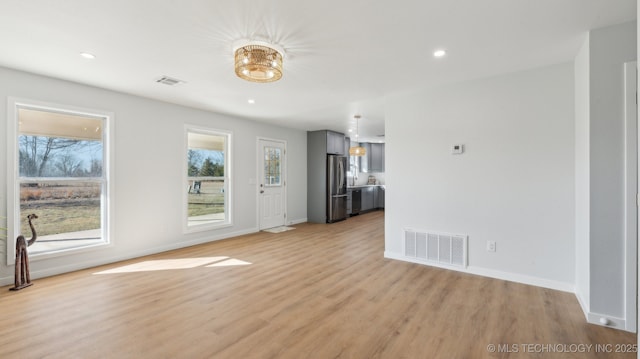 unfurnished living room featuring baseboards, recessed lighting, visible vents, and light wood-style floors