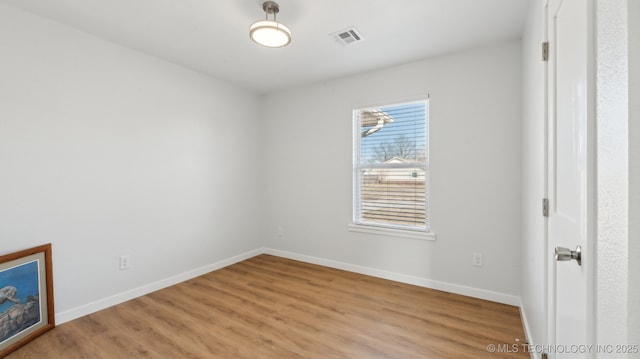 unfurnished bedroom with visible vents, light wood-style flooring, and baseboards