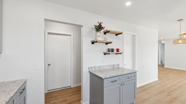 kitchen with recessed lighting, baseboards, light wood-type flooring, gray cabinets, and open shelves