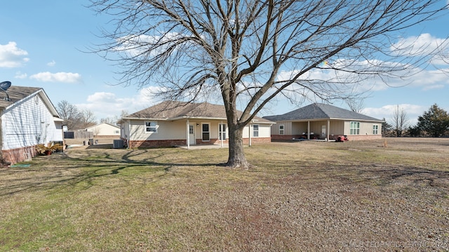 rear view of house with a patio area and a yard